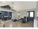 Open-concept living room featuring vaulted ceilings, gray walls, and modern furnishings at 7023 Mustang Ct, Martinsville, IN 46151
