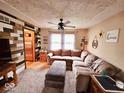 Inviting living room with a modern accent wall, plush seating, and neutral tones for a cozy atmosphere at 7231 W Anton Way, New Palestine, IN 46163