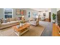 Inviting living room with a neutral palette, stylish furnishings, and abundant natural light, seamlessly connected to the kitchen at 733 Keepsake Run, Greenwood, IN 46143