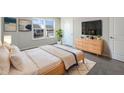 Serene main bedroom with a plush bed, stylish dresser, TV, and plenty of natural light at 733 Keepsake Run, Greenwood, IN 46143