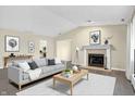 Bright living room boasts a fireplace, neutral paint, and a cozy seating area with stylish decor at 7607 Farm View E Cir, Indianapolis, IN 46256