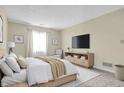 Serene main bedroom with natural light, a comfortable bed, and a sleek entertainment center at 7607 Farm View E Cir, Indianapolis, IN 46256