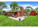 An outdoor patio with furniture and a charming brick fireplace at 917 Stockton St, Indianapolis, IN 46260