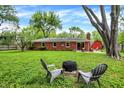 Expansive backyard featuring a fire pit and mature trees for outdoor enjoyment at 917 Stockton St, Indianapolis, IN 46260