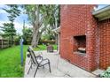 Patio featuring a brick fireplace and comfortable seating area for relaxation at 917 Stockton St, Indianapolis, IN 46260