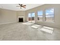 Spacious living room features a fireplace, sliding door access to a deck, and large windows at 943 Foxglove St, Lebanon, IN 46052
