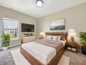 Relaxing main bedroom with large bed, mounted television, and view of neighborhood at 943 Foxglove St, Lebanon, IN 46052