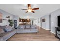 Open concept living room featuring hardwood floors, modern furnishings, and a seamless flow to the kitchen at 972 Redwood Dr, Franklin, IN 46131