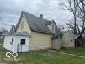 Side view of home showing siding, roof, and fenced in lawn at 11147 Exchange St, Indianapolis, IN 46259