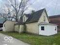 Exterior side view of home with light colored siding and grey roof at 11147 Exchange St, Indianapolis, IN 46259