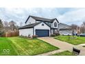 Spacious home with a two-car garage, manicured lawn, and a long driveway at 12555 Wolford Dr, Fishers, IN 46038