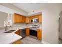 Modern kitchen featuring stainless steel appliances, quartz countertops, and wood cabinets at 1561 Brookfield Cir, Franklin, IN 46131