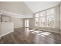 Bright living room with hardwood floors, large windows, and a vaulted ceiling at 1561 Brookfield Cir, Franklin, IN 46131