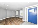 Entryway featuring wood floors, light gray walls, blue front door and a view to living area at 1653 S Delaware St, Indianapolis, IN 46225