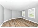 Bright, spacious living room with modern flooring and natural light from two windows at 1653 S Delaware St, Indianapolis, IN 46225