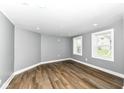 Bright living room with wood floors, neutral paint and double-hung windows at 1653 S Delaware St, Indianapolis, IN 46225