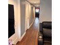 Hallway with laminate flooring, modern doors, and neutral paint at 1921 W Michigan St, Indianapolis, IN 46222