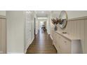 Inviting hallway with elegant wainscoting, wood floors, and decor at 19970 Edwick Dr, Westfield, IN 46074