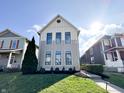 Attractive two-story home with manicured lawn and blue sky at 2037 Ruckle St, Indianapolis, IN 46202