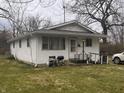 Single-story home with a compact front porch and accessibility ramp on a partly sunny day at 2194 N Riley Ave, Indianapolis, IN 46218
