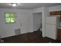 Shows the kitchen with a back door and some damage on the walls at 2194 N Riley Ave, Indianapolis, IN 46218