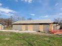Exterior view of a plywood-covered house with roof and detached garage at 2860 S Rybolt Ave, Indianapolis, IN 46241