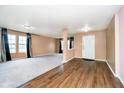 Inviting living room featuring hardwood flooring, neutral paint, large windows, and elegant window treatments at 2885 Holiday Way, Greenwood, IN 46143