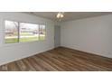Inviting living room boasting laminate floors, large window, and fresh white walls at 380 Parkway St, Whiteland, IN 46184
