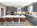 Modern kitchen boasts stainless steel appliances, a large island with seating, and stylish gray cabinetry at 540 Galveston Ln, Westfield, IN 46074