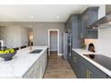 Modern kitchen boasts stainless steel appliances, a large island with seating, and stylish gray cabinetry at 540 Galveston Ln, Westfield, IN 46074