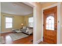Inviting living room with hardwood floors, bright yellow walls, and a view of the front door at 5915 Lowell Ave, Indianapolis, IN 46219
