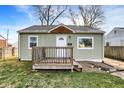 Quaint single-story home with light green siding, a front porch, and a manicured lawn at 621 Melvenia St, Indianapolis, IN 46219