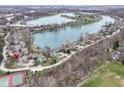 Gorgeous aerial view of a lakefront community showcasing lush greenery and a tranquil lake at 7160 Harbour, Indianapolis, IN 46240