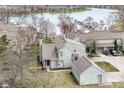 An aerial view shows the home's proximity to the water, detached garage, and the surrounding green spaces at 7160 Harbour, Indianapolis, IN 46240