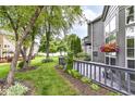 Relaxing backyard with mature trees, views of neighboring properties, and outdoor deck at 7160 Harbour, Indianapolis, IN 46240