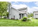 Well-maintained home boasts lush green lawns, shake siding, and inviting outdoor space perfect for relaxing at 7160 Harbour, Indianapolis, IN 46240