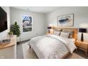Comfortable bedroom with large window, side tables, lamps, and a neutral color scheme at 7228 Muirfield Pl, Indianapolis, IN 46237