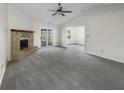 Spacious living room featuring vaulted ceilings, stone fireplace, new carpet, and plenty of natural light at 7228 Muirfield Pl, Indianapolis, IN 46237