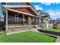 Beautifully landscaped front yard featuring a well-manicured lawn and a covered front porch, providing curb appeal at 934 E Minnesota St, Indianapolis, IN 46203