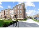 Lovely new construction townhome with brick elevation, sidewalk, and manicured lawn at 13783 Tender Dr, Carmel, IN 46032