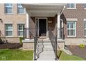 Inviting front porch with a classic design, featuring a brick facade and decorative railings at 13783 Tender Dr, Carmel, IN 46032