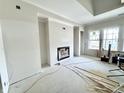 Living room features a fireplace, large windows, and modern design elements at 1463 Crosstie Cir, Westfield, IN 46074