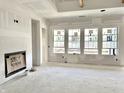 Spacious living room featuring four large windows and a fireplace, ready for customization at 1463 Crosstie Cir, Westfield, IN 46074