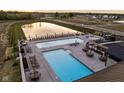 Stunning community pool area featuring ample seating and a serene pond at 1463 Crosstie Cir, Westfield, IN 46074