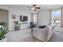 Bright living area with accent wall, ceiling fan, and neutral colors with comfortable seating at 15152 Fallen Leaves Ln, Noblesville, IN 46060