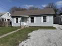 Charming bungalow-style home featuring light blue siding, white trim, and a well-manicured lawn at 2406 E 10Th St, Anderson, IN 46012