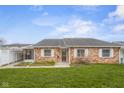 Inviting single-story brick home with manicured lawn and a convenient carport at 2770 Two Worlds Dr, Columbus, IN 47201