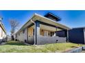 Charming home with covered porch and wood siding, presenting a welcoming facade at 3006 W 10Th St, Indianapolis, IN 46222