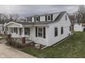 Two-story home with white siding, black shutters, and front porch and side yard at 319 Alice St, Shelbyville, IN 46176