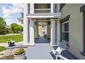 Welcoming front porch with grand columns, offering a serene spot with seating and stylish decor at 3447 Washington Blvd, Indianapolis, IN 46205